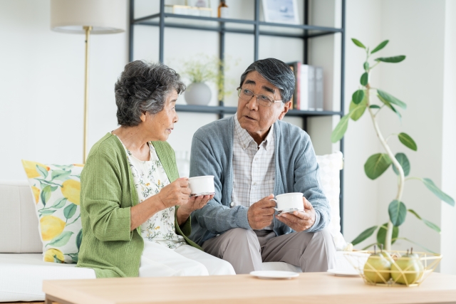 高齢夫婦がソファで話をしている画像